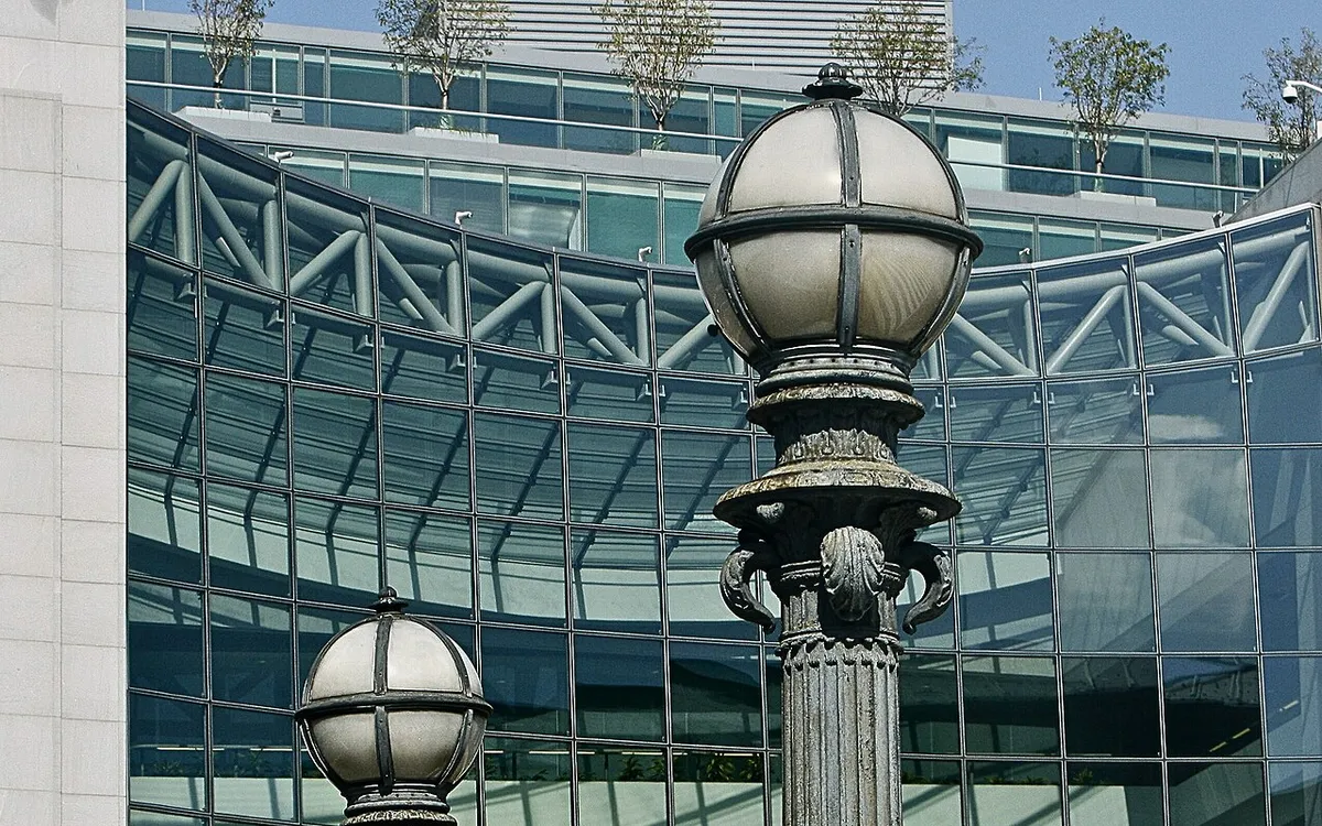 Bronze street lamps in front of the curved glass facade of the U.S. Securities and Exchange Commission headquarters in Washington, D.C.